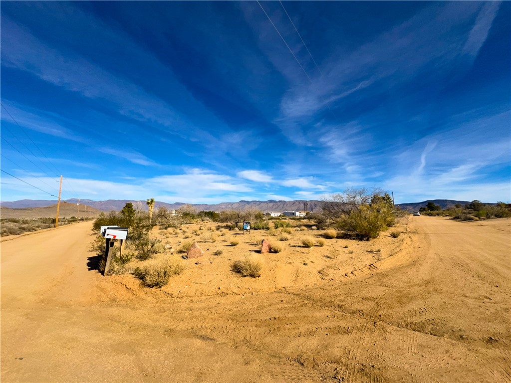 10210 Boulder Road Kingman, AZ 86401 - Photo 15 of 30 View of dirt / gravel road featuring a mountain view and view of desert