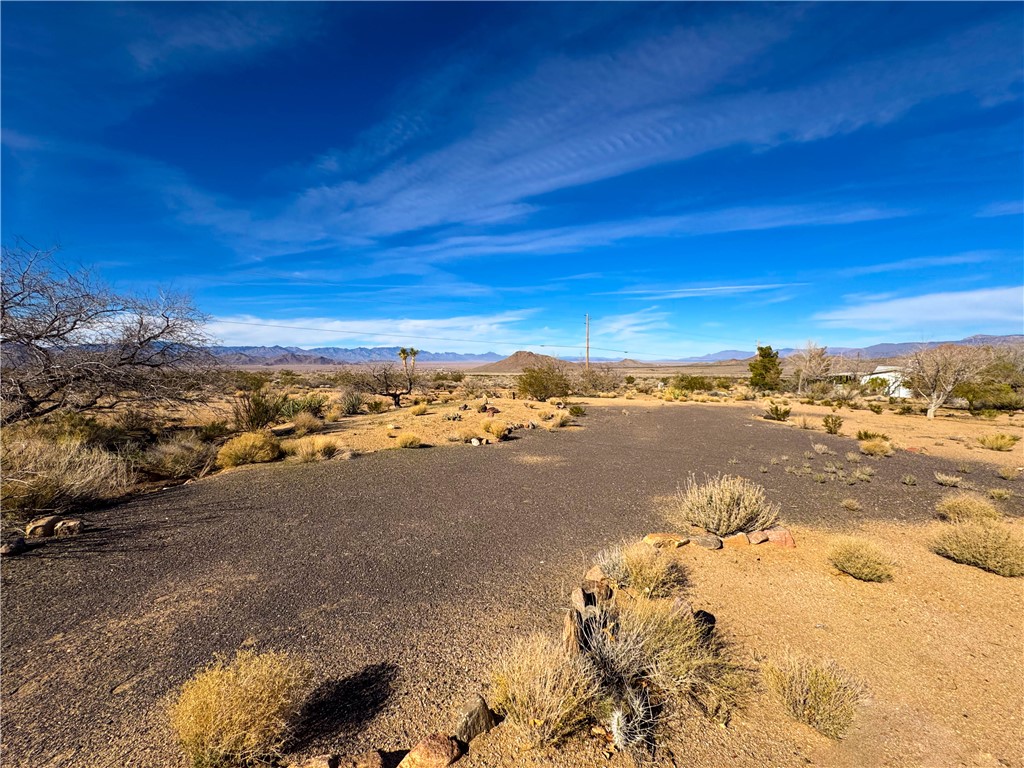 10210 Boulder Road Kingman, AZ 86401 - Photo 9 of 30 View of yard featuring a mountain view and a desert view