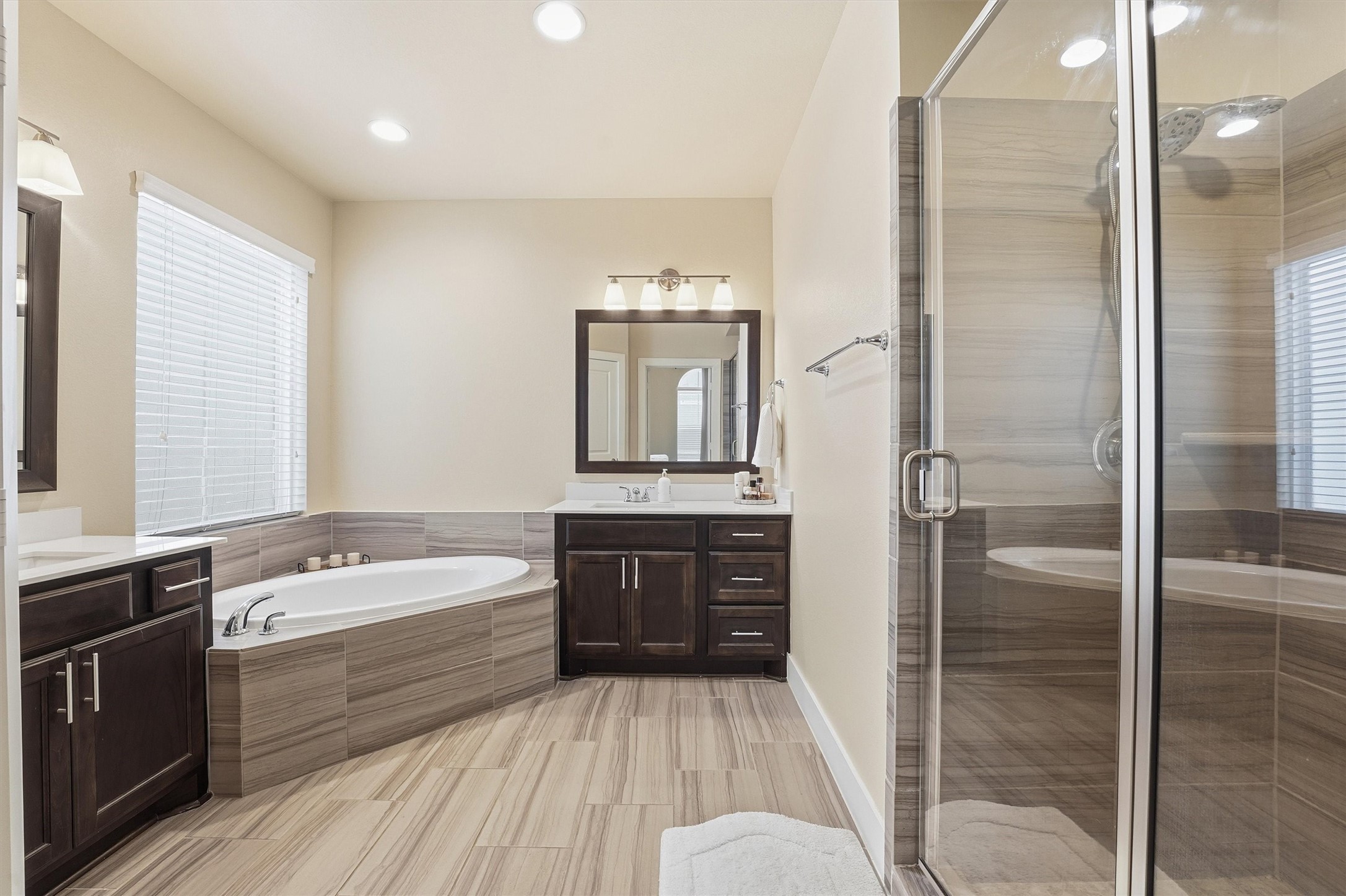 2714 Freund Street Houston, TX 77003 - Photo 18 of 29 a bathroom with a tub a sink and a large mirror