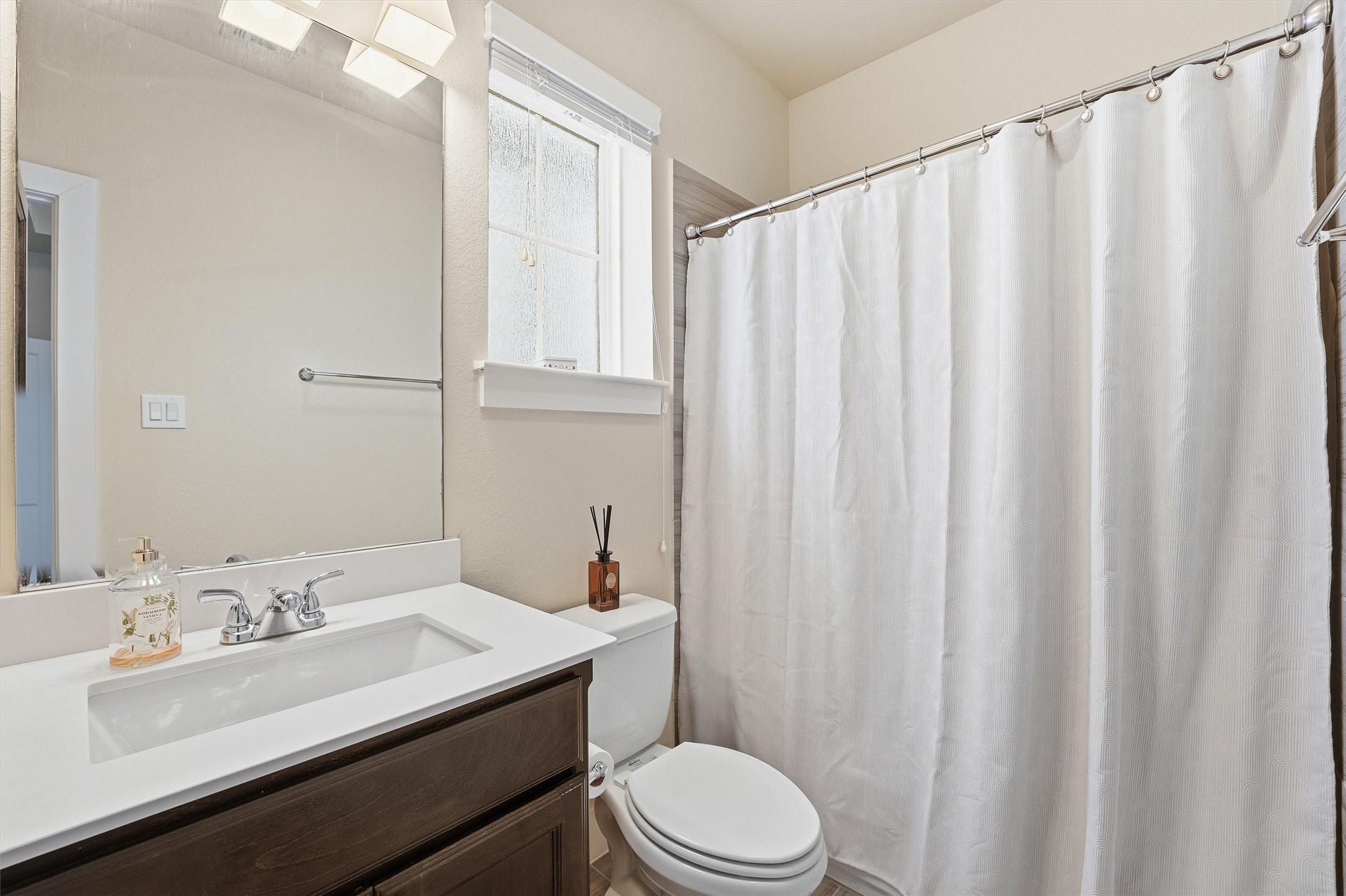 2714 Freund Street Houston, TX 77003 - Photo 22 of 29 a bathroom with a sink a toilet and shower curtain