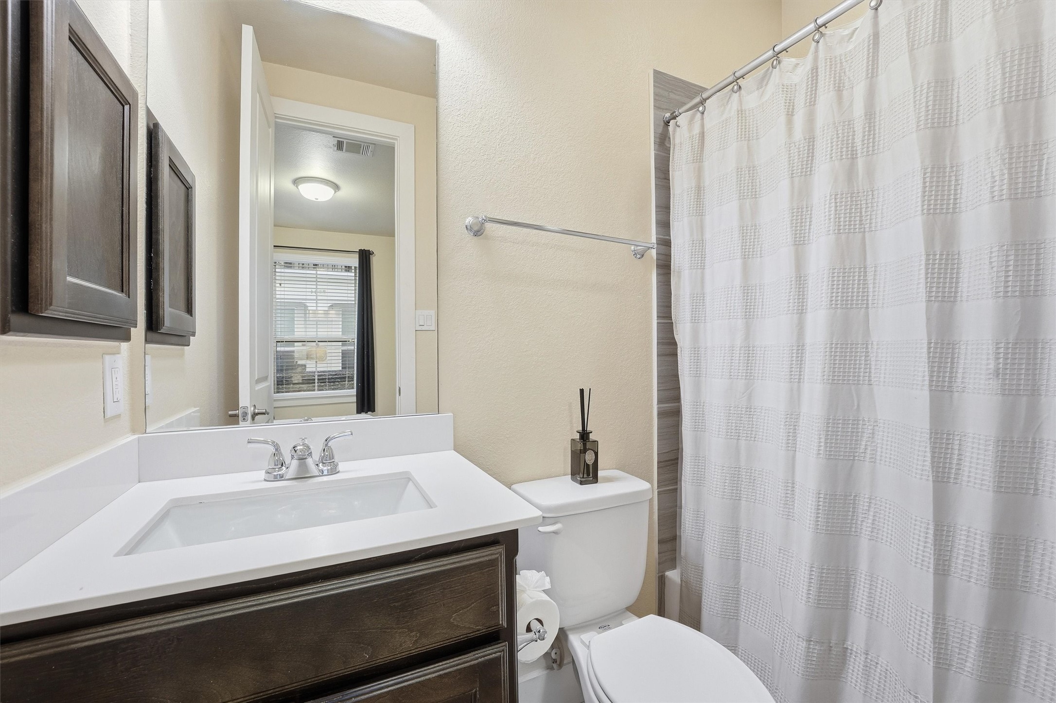 2714 Freund Street Houston, TX 77003 - Photo 26 of 29 a bathroom with a sink a toilet and shower curtain