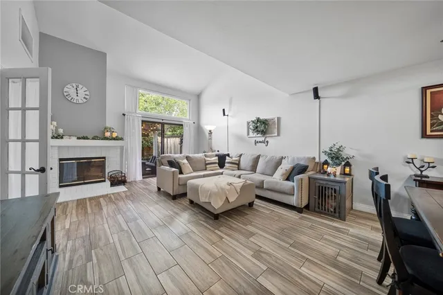 a living room with furniture fireplace and flat screen tv