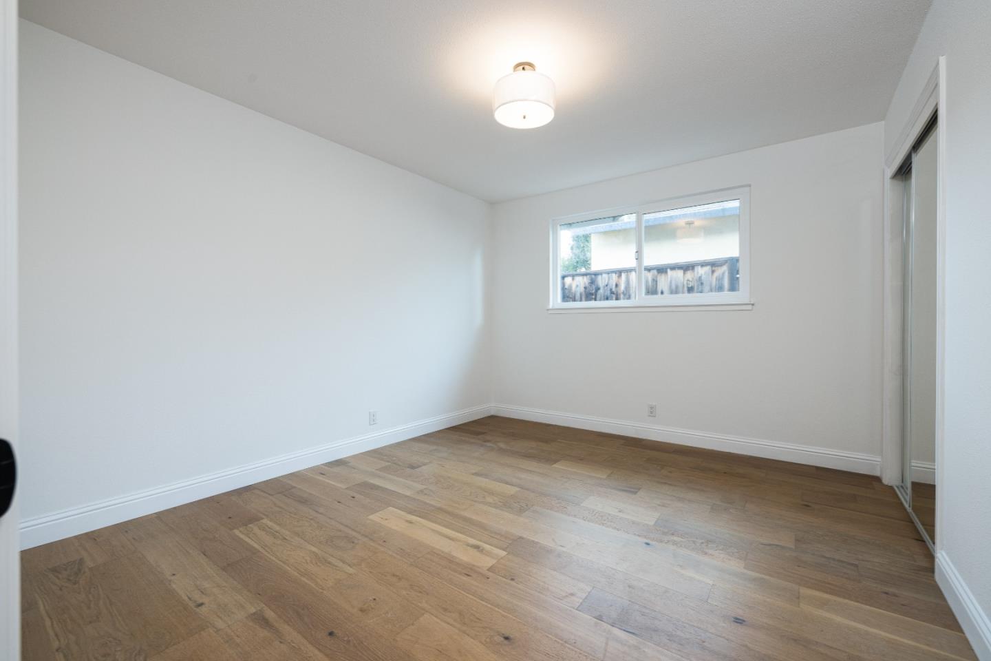 2005 Mento Drive Fremont, CA 94539 - Photo 15 of 22 an empty room with wooden floor and windows