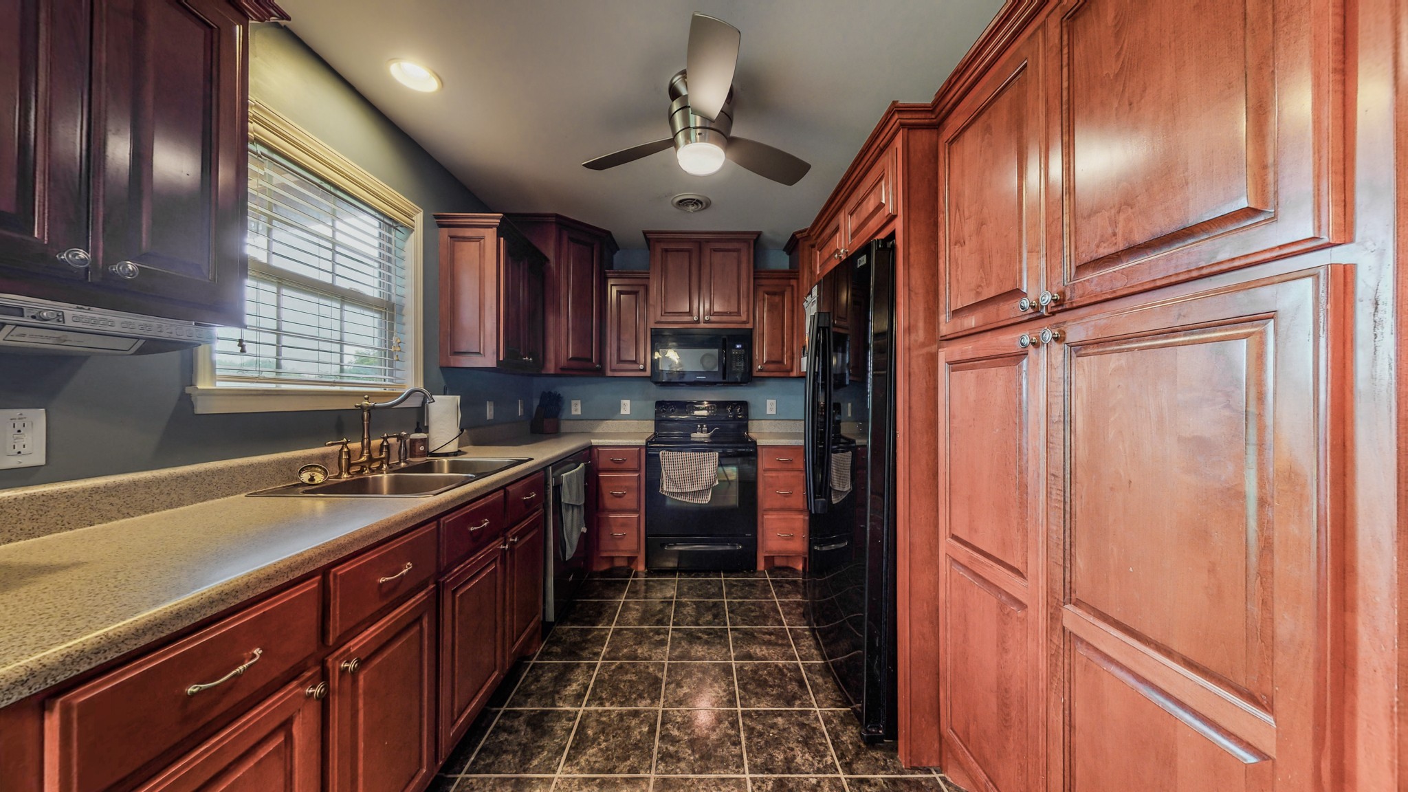 2981 Lewis Road Santa Fe, TN 38482 - Photo 11 of 32 a kitchen with stainless steel appliances granite countertop a sink stove and refrigerator