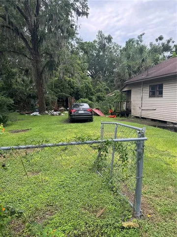 a view of a house with a yard and sitting area