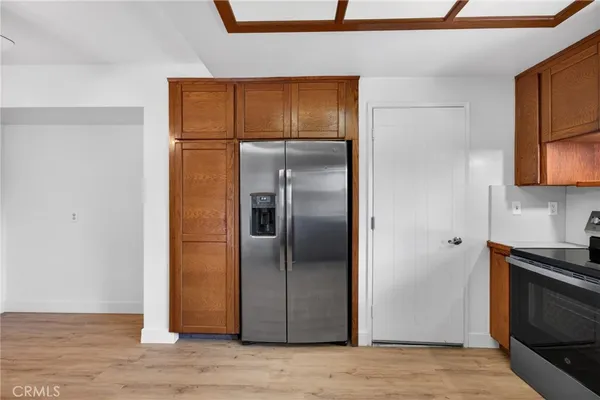a metallic refrigerator freezer sitting in a kitchen