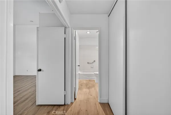 a view of a hallway with wooden floor