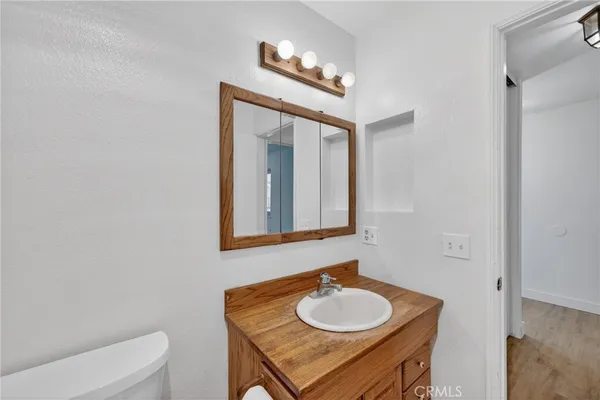 a bathroom with a toilet a sink and a mirror