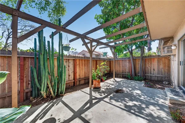 a view of a backyard with table and chairs and a large tree