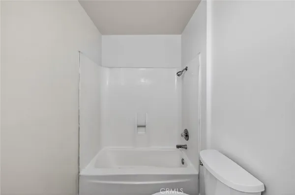 a bathroom with a bathtub and toilet