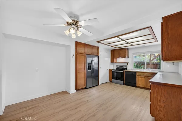 a kitchen with stainless steel appliances granite countertop a refrigerator a stove top oven a sink and dishwasher