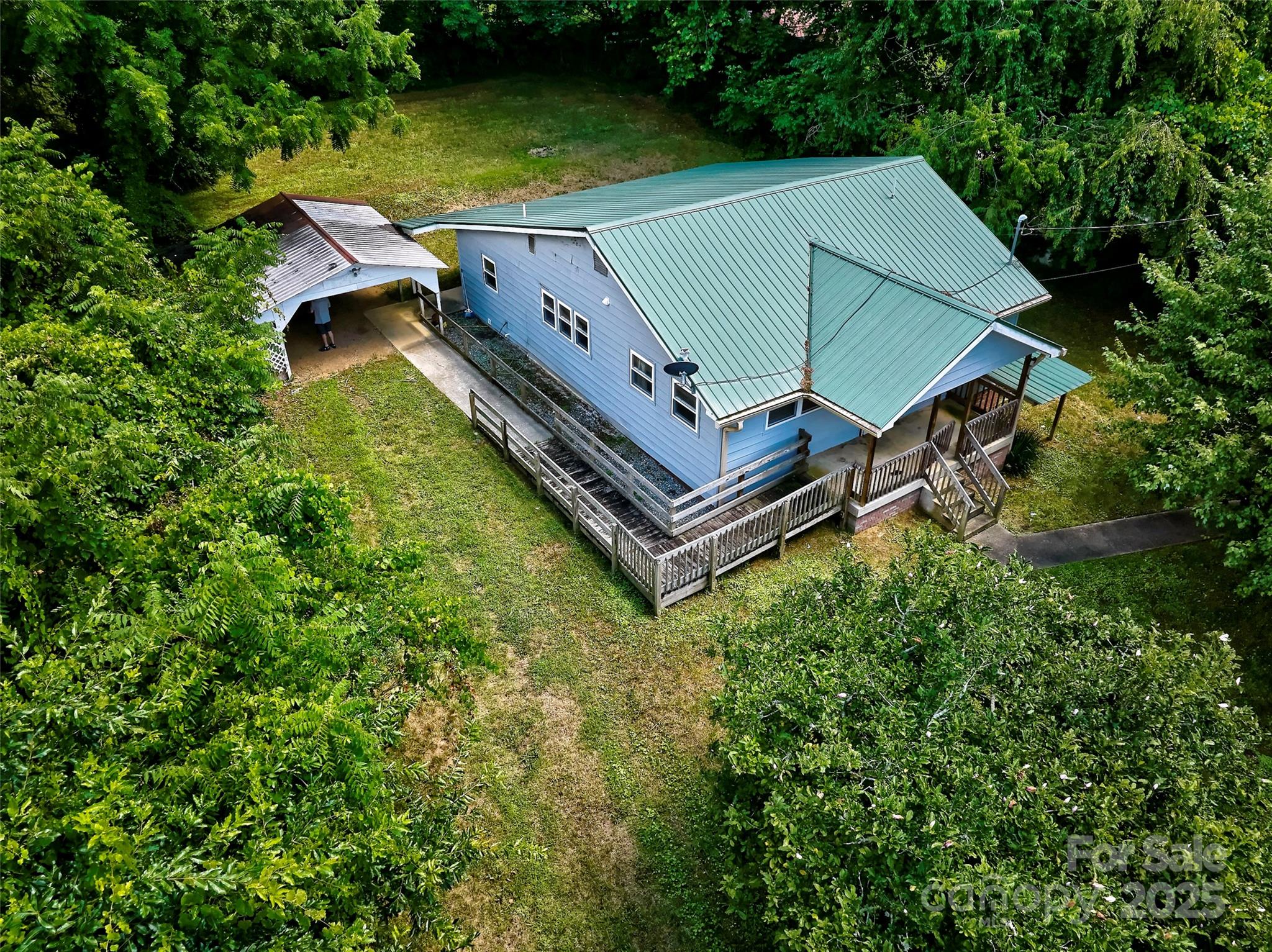 an aerial view of a house with swimming pool and garden