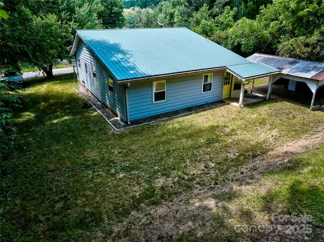 an aerial view of a house with a yard