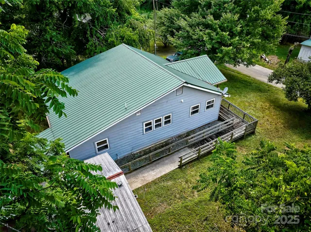 an aerial view of a house with a yard