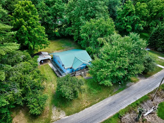 an aerial view of a house with a yard
