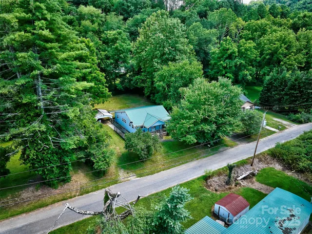 an aerial view of a house with outdoor space pool seating area and yard