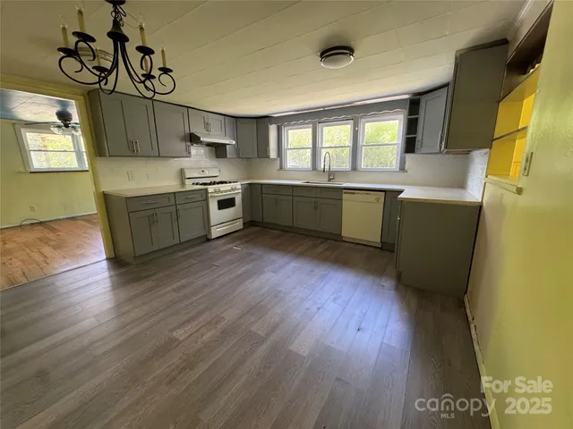 a kitchen with a wooden floor and window