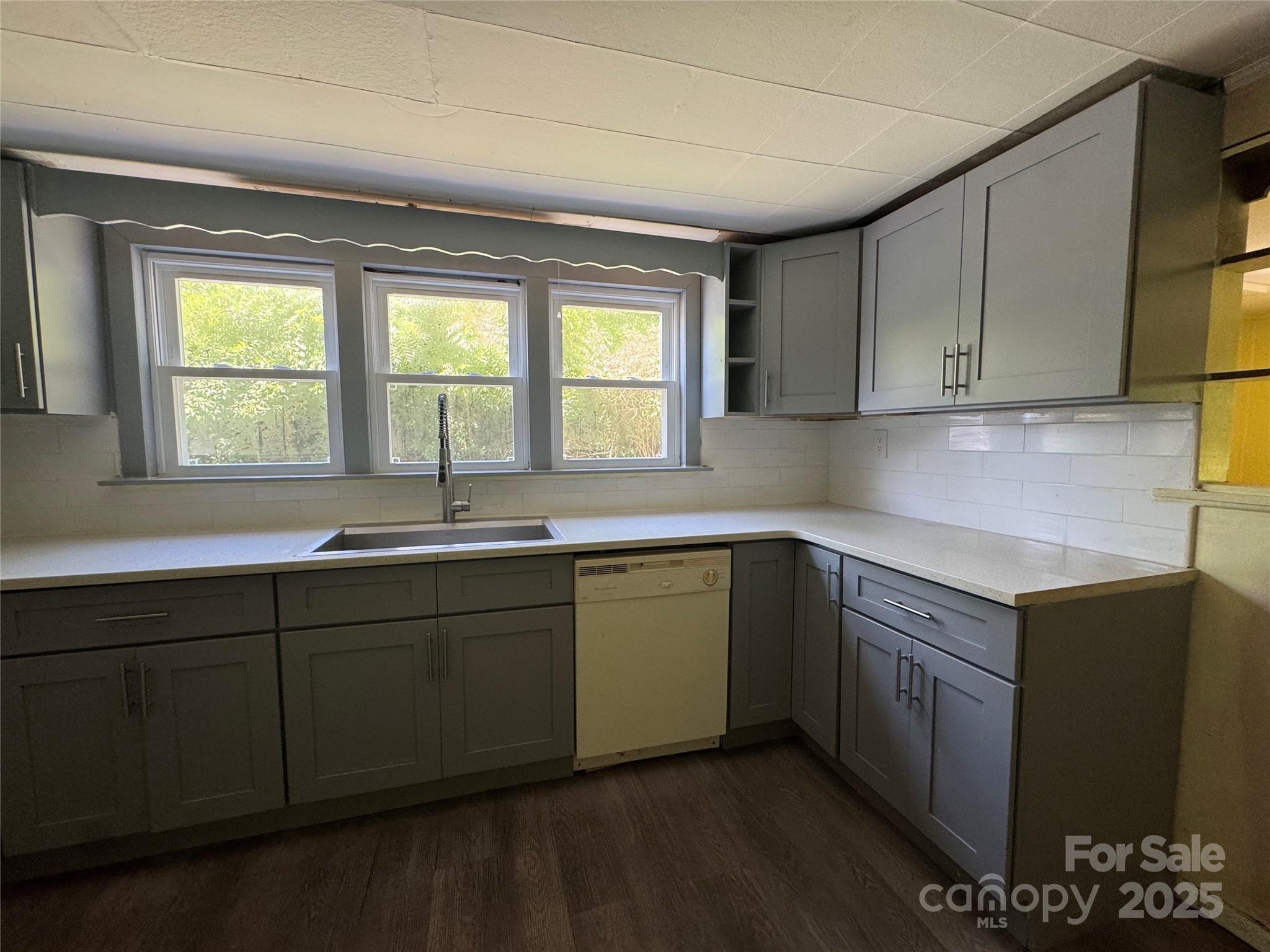 111 Kenneth Cooper Road Whittier, NC 28789 - Photo 29 of 30 a kitchen with sink window and cabinets