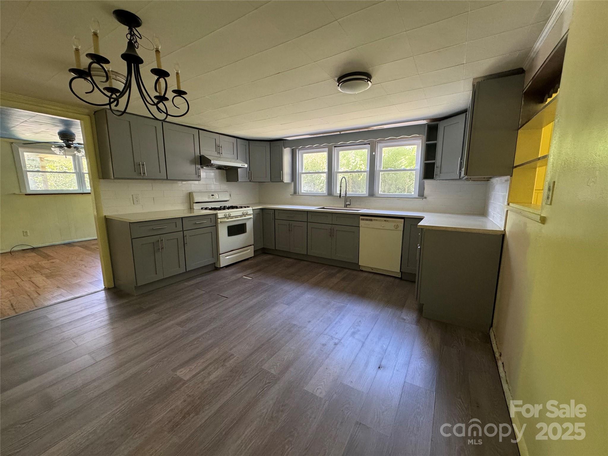 111 Kenneth Cooper Road Whittier, NC 28789 - Photo 6 of 30 a kitchen with lots of counter top space and wooden floor