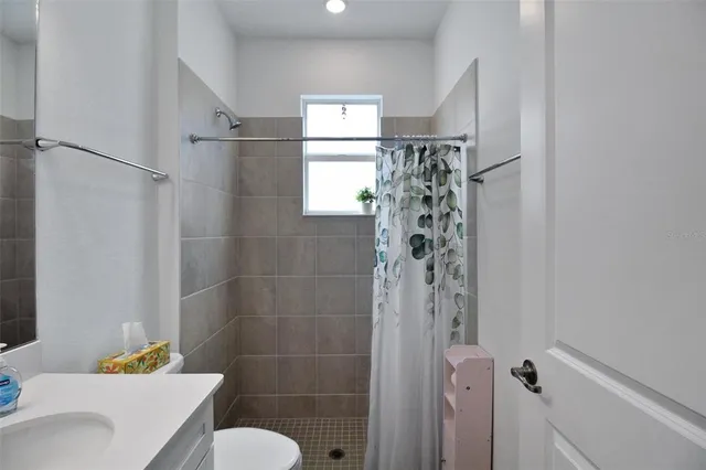 a bathroom with a shower and a toilet