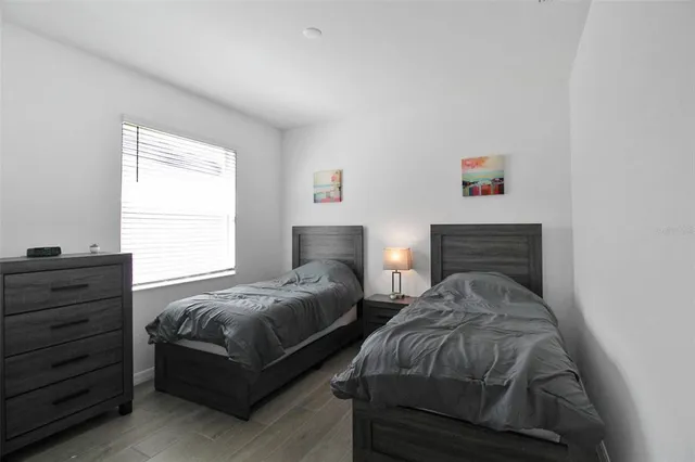 a bedroom with two beds and a window