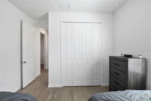 a view of bedroom with wooden floor