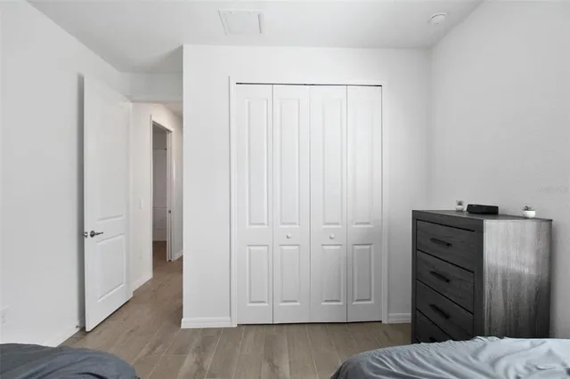 a view of bedroom with wooden floor