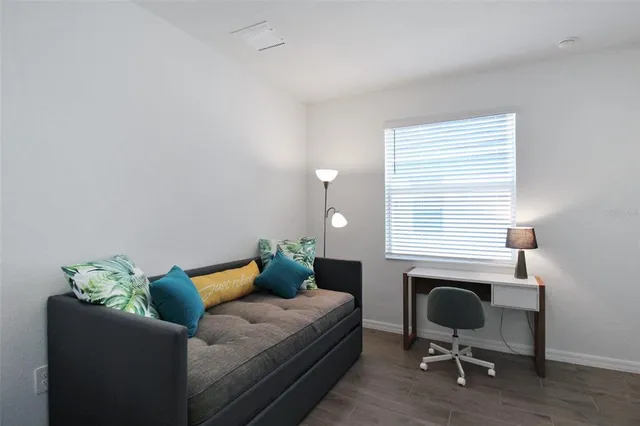 a living room with furniture and a chair