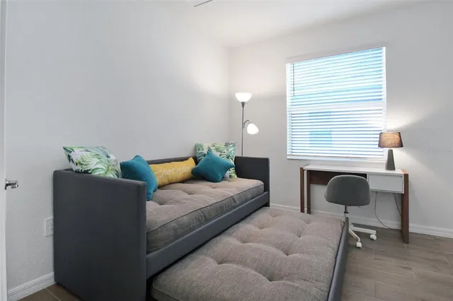 a bedroom with a bed and a chair