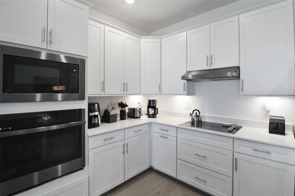 a kitchen with stainless steel appliances a refrigerator stove and microwave