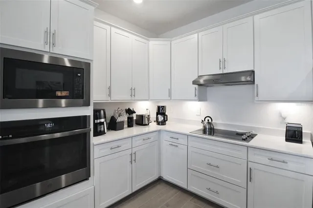 a kitchen with stainless steel appliances a refrigerator stove and microwave