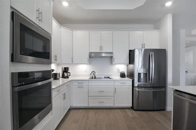 a kitchen that has a sink and a stove in it