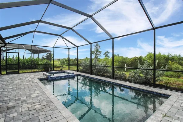 a swimming pool with outdoor seating and yard