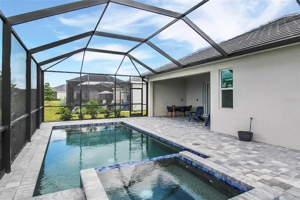 a view of swimming pool with seating area
