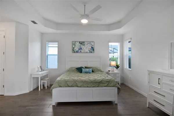 a spacious bedroom with a large bed and a couch