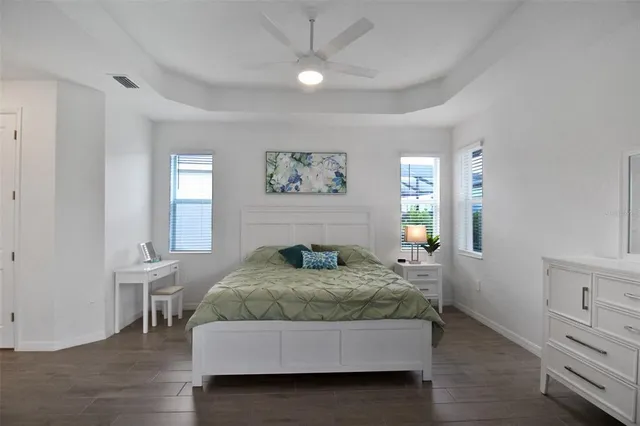 a spacious bedroom with a large bed and a couch