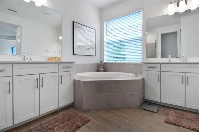 a bathroom with a double vanity sink mirror and double