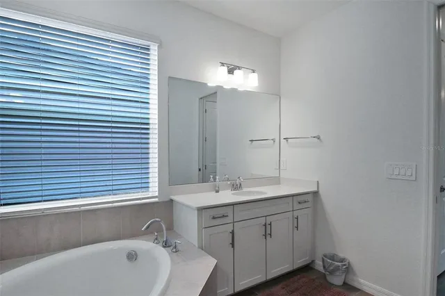 a bathroom with a sink double vanity and a shower