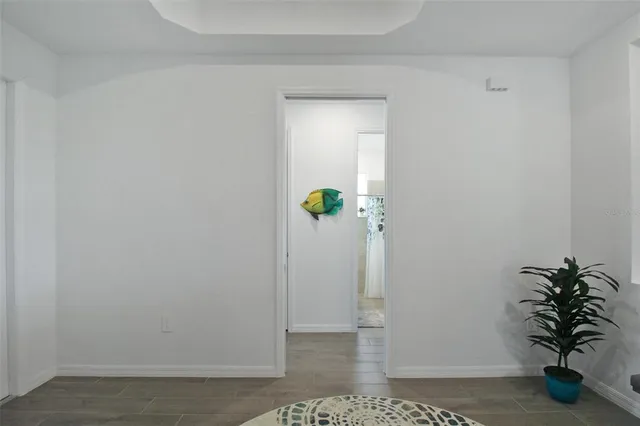 a view of a hallway with wooden door