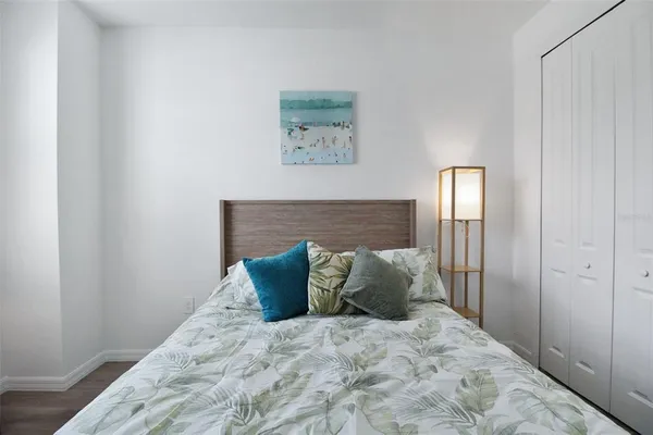 a large bed sitting in a bedroom and painting on the wall