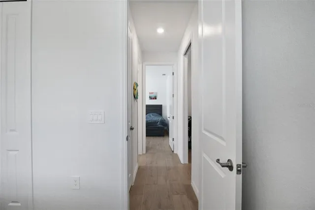 a view of a hallway with wooden shelves