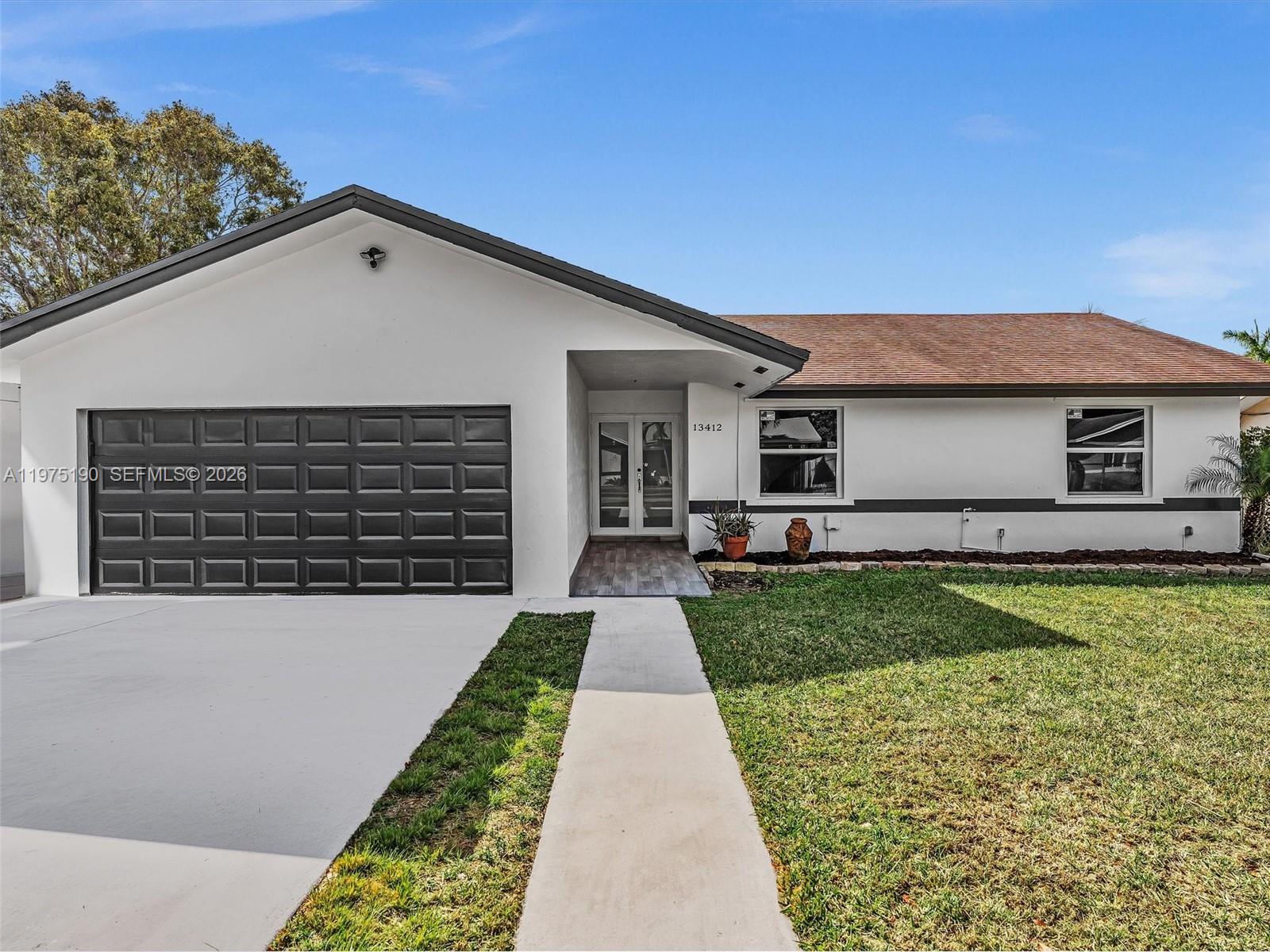 a front view of a house with garden