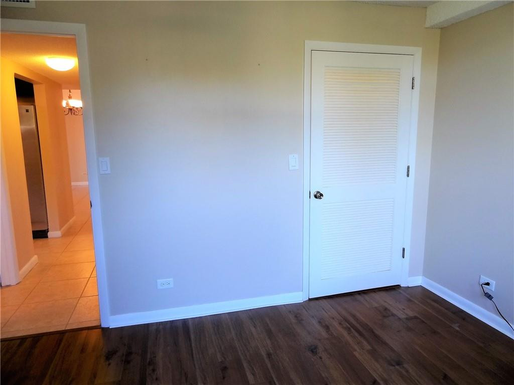 3670 Inverrary Drive, Unit 1L Lauderhill, FL 33319 - Photo 15 of 26 a view of an empty room with wooden floor and a window
