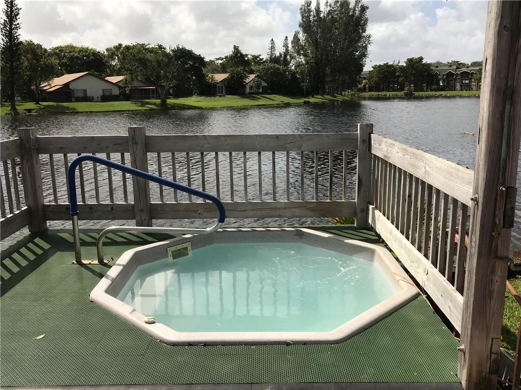 3670 Inverrary Drive, Unit 1L Lauderhill, FL 33319 - Photo 21 of 26 a view of a swimming pool from a lake