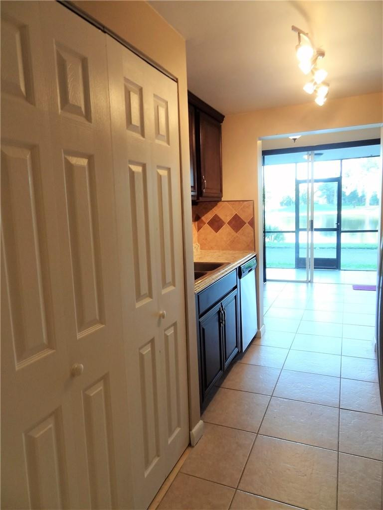 3670 Inverrary Drive, Unit 1L Lauderhill, FL 33319 - Photo 5 of 26 a kitchen with stainless steel appliances granite countertop a refrigerator and a sink
