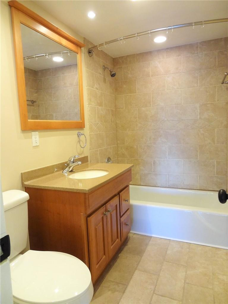 3670 Inverrary Drive, Unit 1L Lauderhill, FL 33319 - Photo 8 of 26 a bathroom with a sink a toilet and bathtub