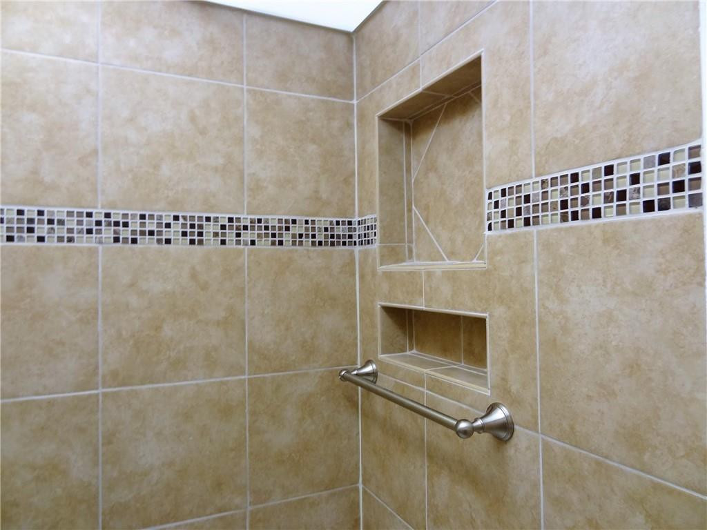 3670 Inverrary Drive, Unit 1L Lauderhill, FL 33319 - Photo 9 of 26 a bathroom with a shower
