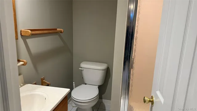 a white toilet sitting next to a bathroom sink