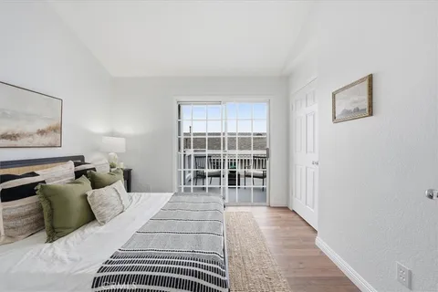 a bedroom with a large bed and a window