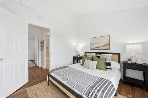 a bedroom with a bed and wooden floor